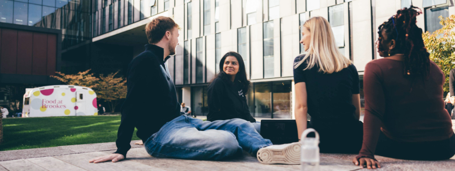 Student group outside on campus all talking to each other