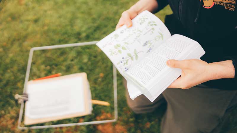 Student looking at geographical identification index handbook