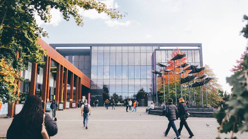 Students walking towards the John Henry Brookes Building.