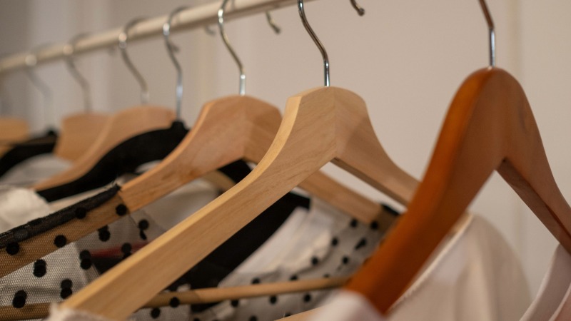A clothing rail with coathangers and clothes
