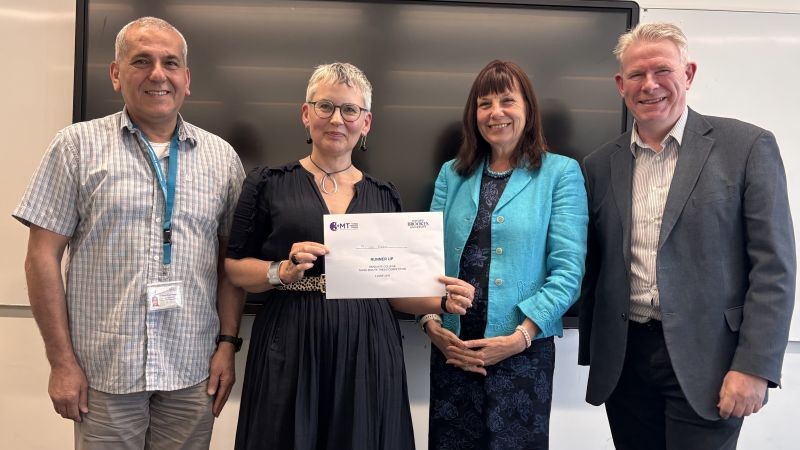 student with certificate and judges