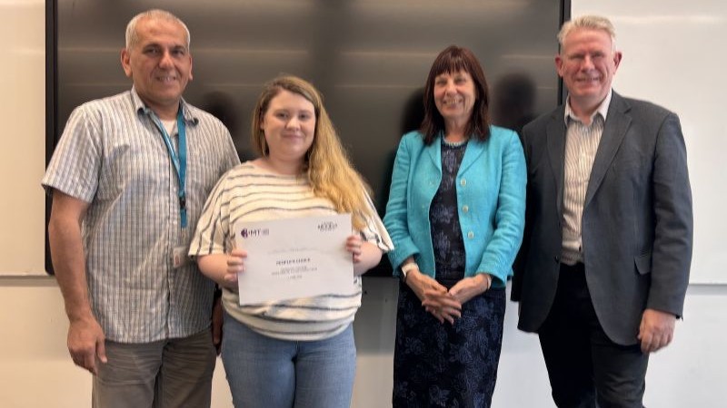 Student with certificate and judges