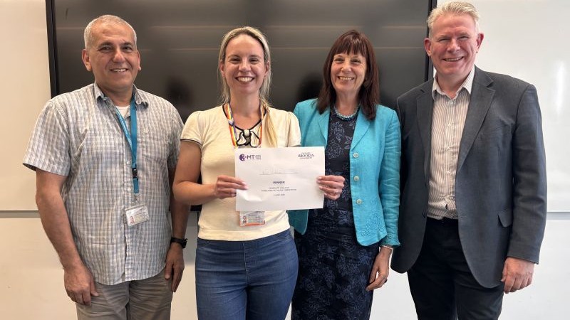 student with certificate and judges