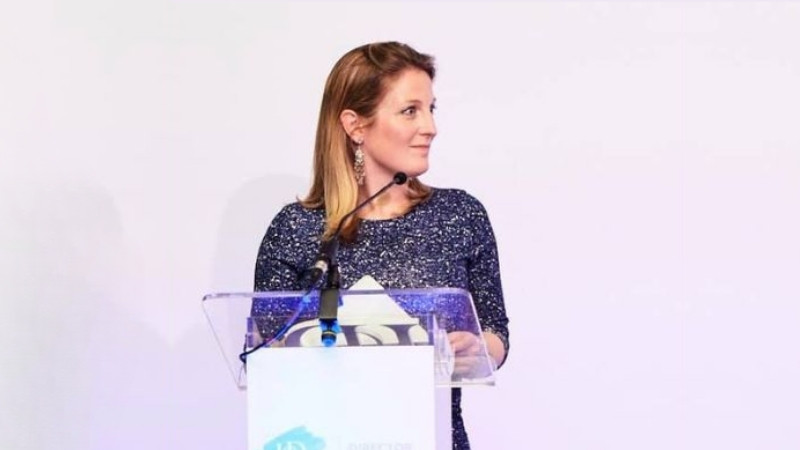 Francesca Salussolia standing at a podium during a speaking engagement.