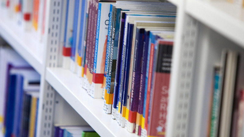 Rows of library books on metal shelves