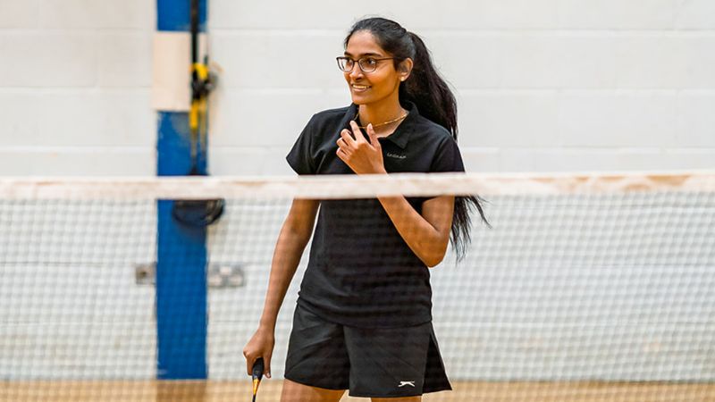 Female student playing badminton