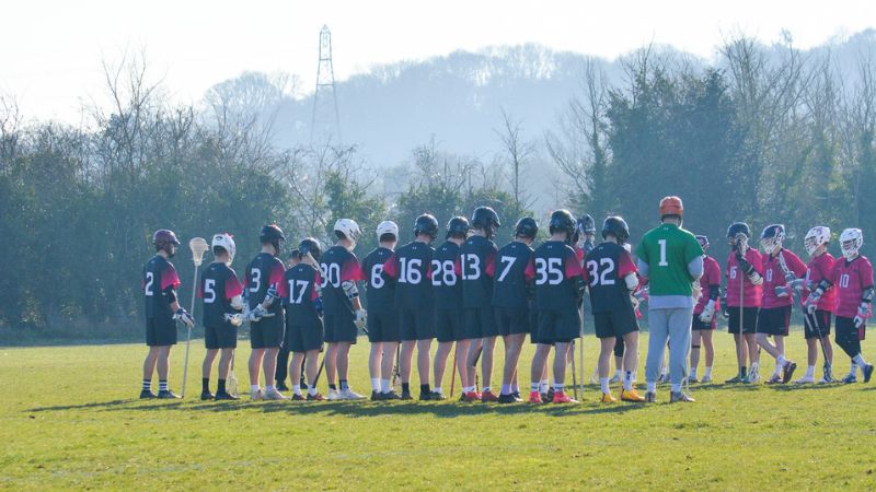 Lacrosse team on grass pitch 