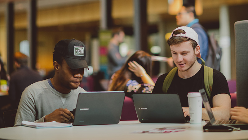 Two Male Law LLB Hons Students studying on campus at Oxford Brookes University