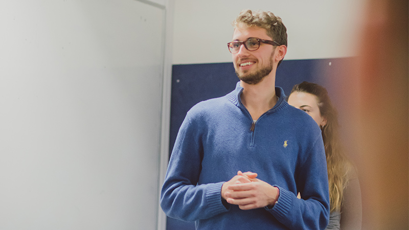 male student presenting to class