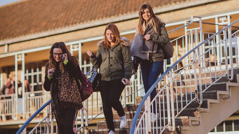Three female students leaving lecture