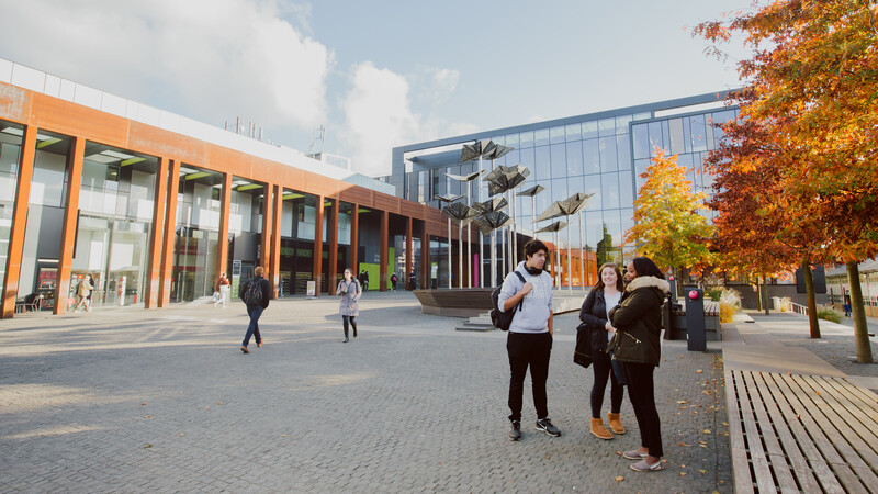 Students on the plazza of the Headington Campus