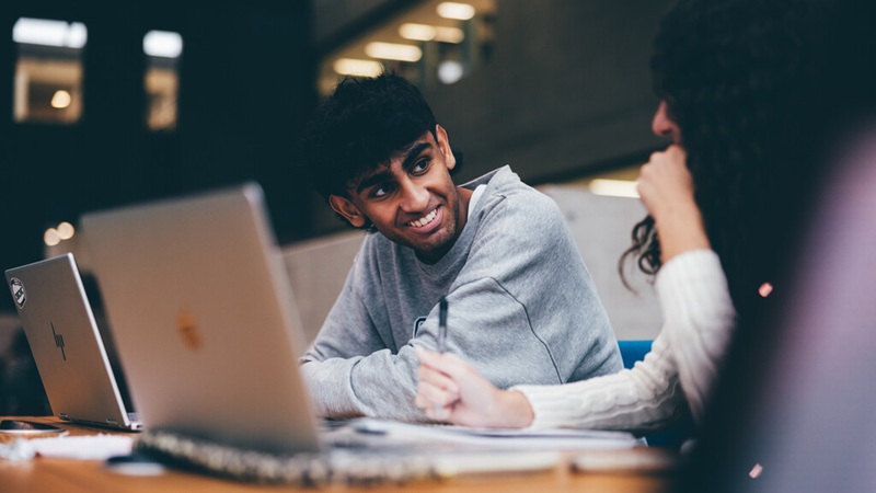 Business school students discussing work