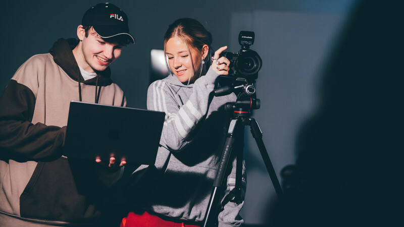 Student using professional camera equipment on site Student using professional camera equipment on site