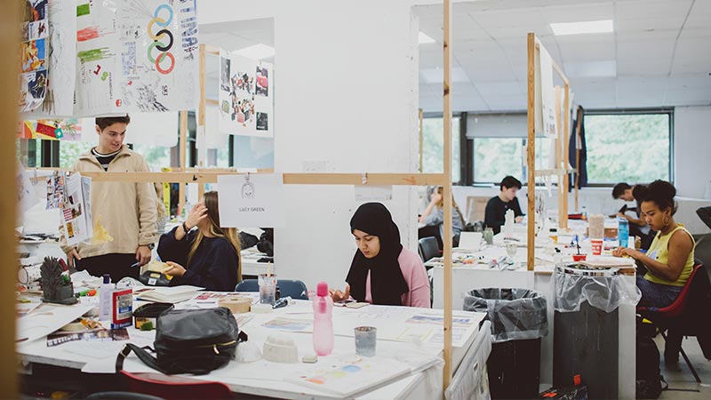 Students working on a art and design project on campus in a studio