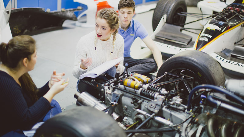 Motorsport students checking an engine