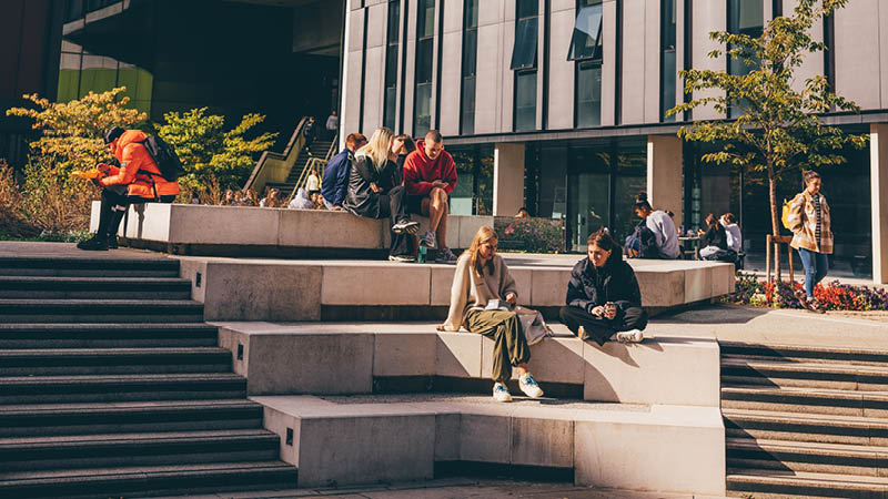 Students relaxing outside on campus