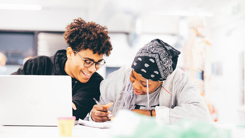 Students sharing a notebook