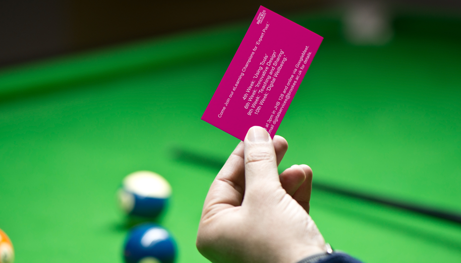 Expert pool image, business card held over a billiards table.
