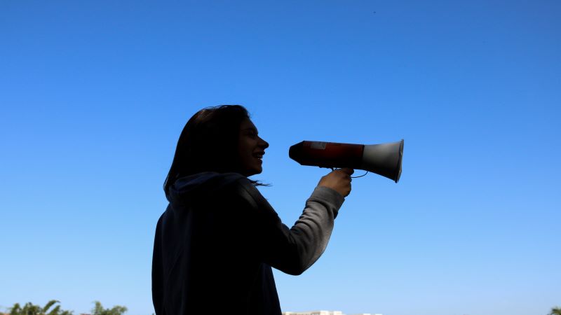 Young woman holding a megaphone