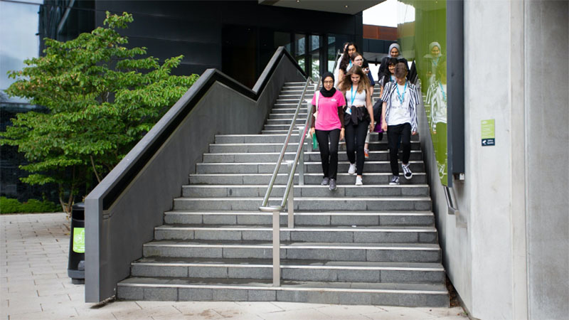 Students walking down external staircase
