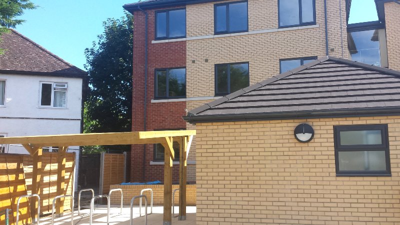 External bicycle storage under wooden canopy