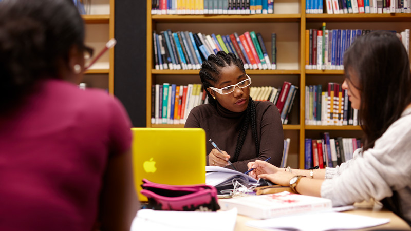 Students working at a table in the library