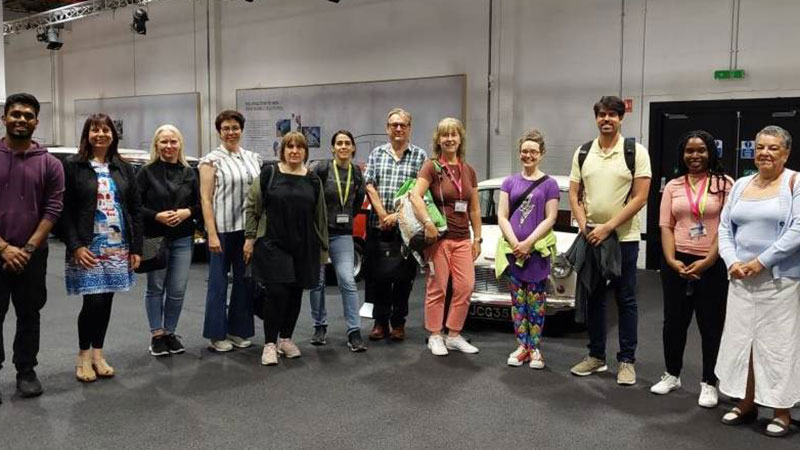 research students in front of a car