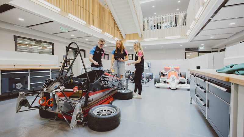 Students stood by a car