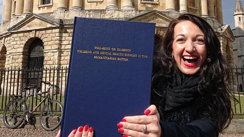 Martina holding her printed dissertation