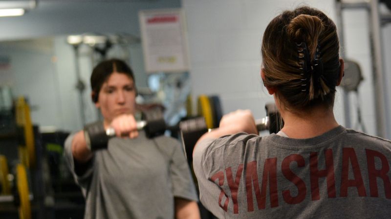Gym user using dumbbells 