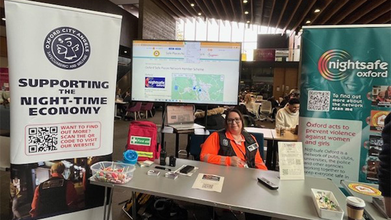 Image of safety stand, with a table with leaflets about personal safety