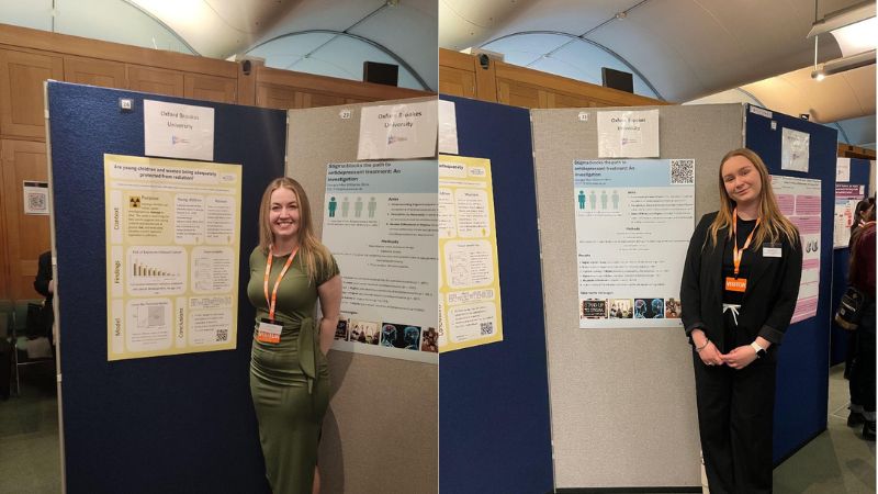 brookes students in front of a panel with posters on it