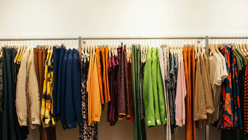 A clothing rail filled with different coloured garments.