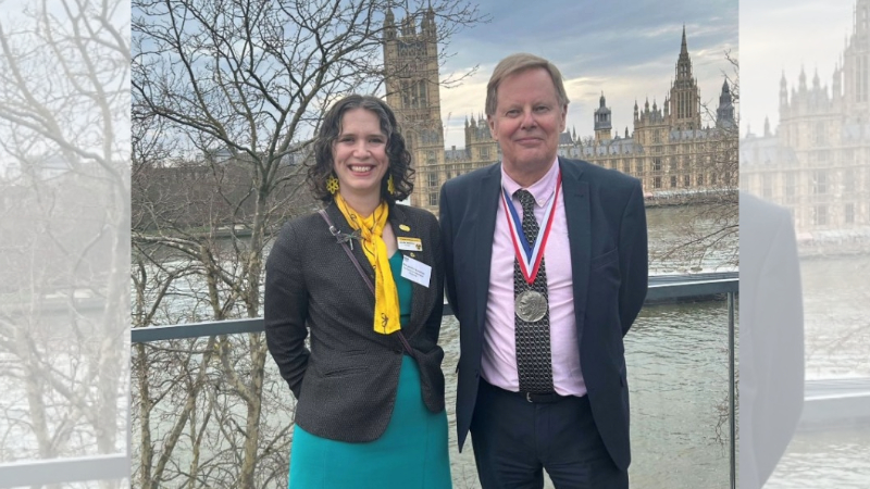 Professor John Harrison and Jennifer Humphries (President of the Society for Radiological Protection) standing outside of parliament. John is wearing the Gray Medal.