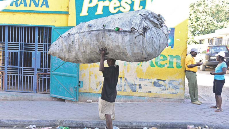 A man carrying a large, heavy load. 