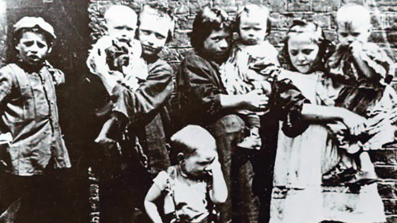 Old black and white photo of a group of children