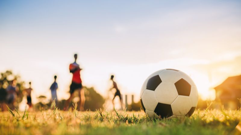 people playing foodball on a sunny field