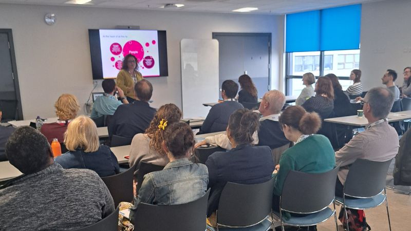 people at an event listening to a presenter