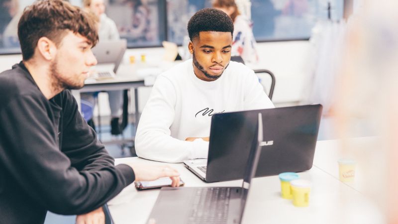 Students with laptops.