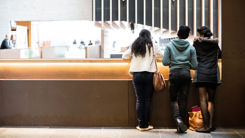 Three students stood in the John henry Brookes Building, Headington Campus.