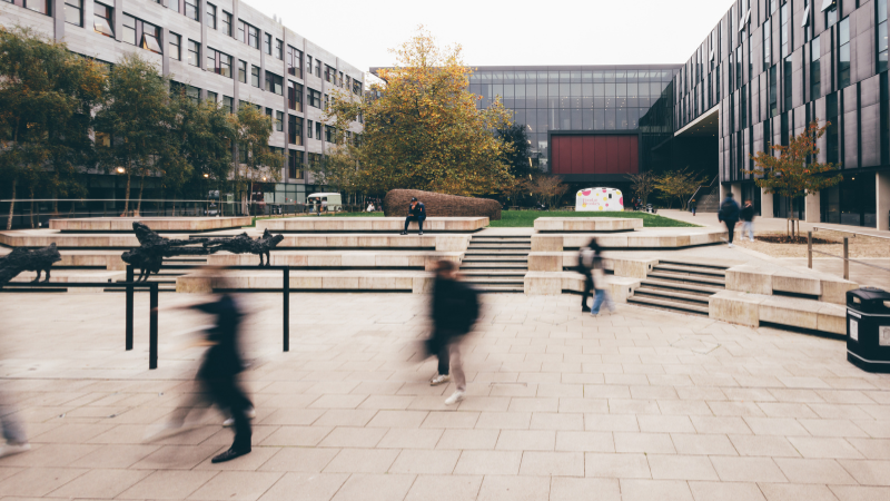Students walking through the courtyard at Headington Campus.