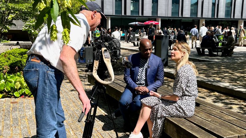 Someone setting up a camera for filming an interview.