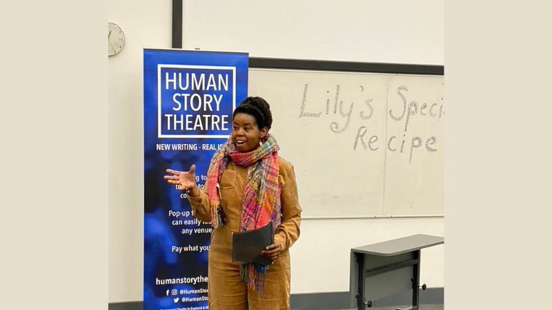 speaker at an even in front of a pull-up banner