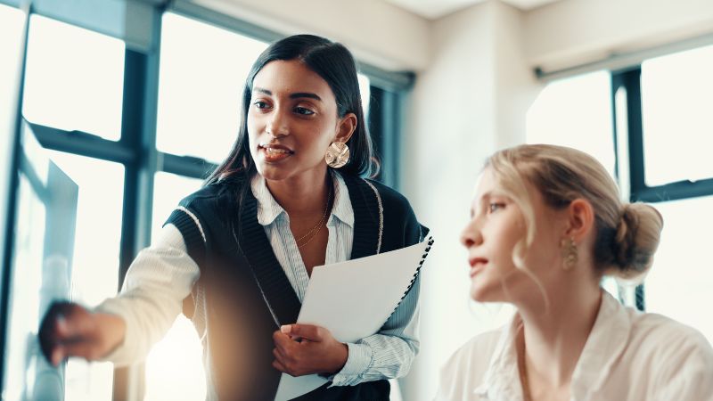 two women looking at a screen